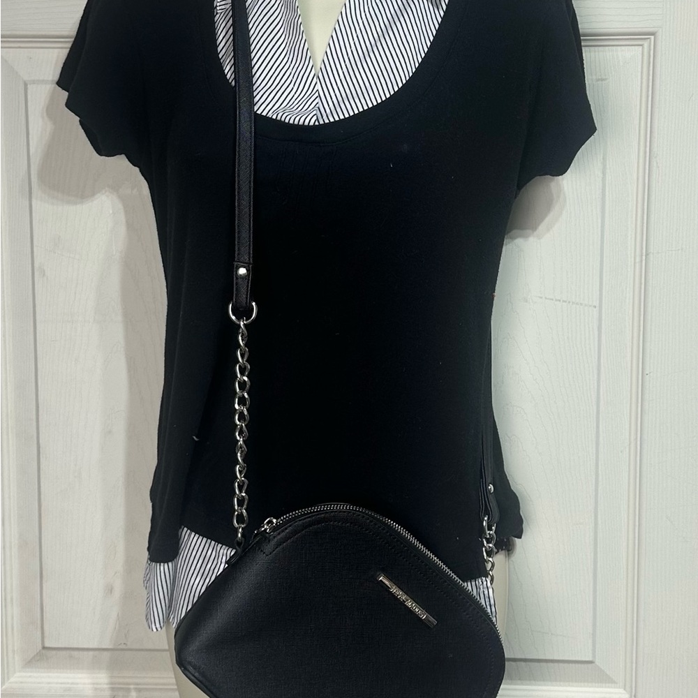 This is a Steve Madden black dome crossbody bag featuring silver hardware